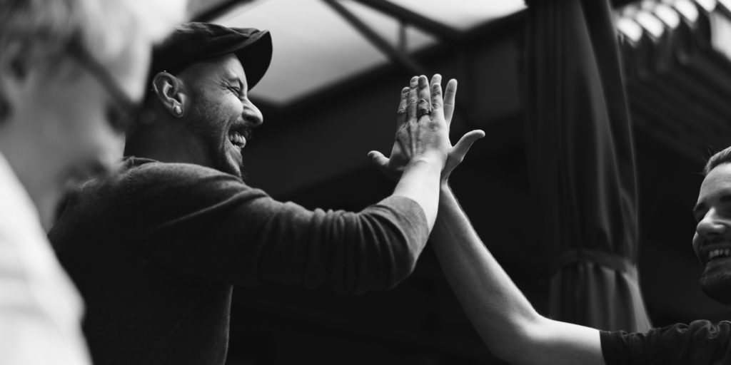 shutterstock_565936849-bw men high fiving