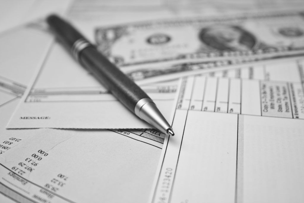 pen on paper with money