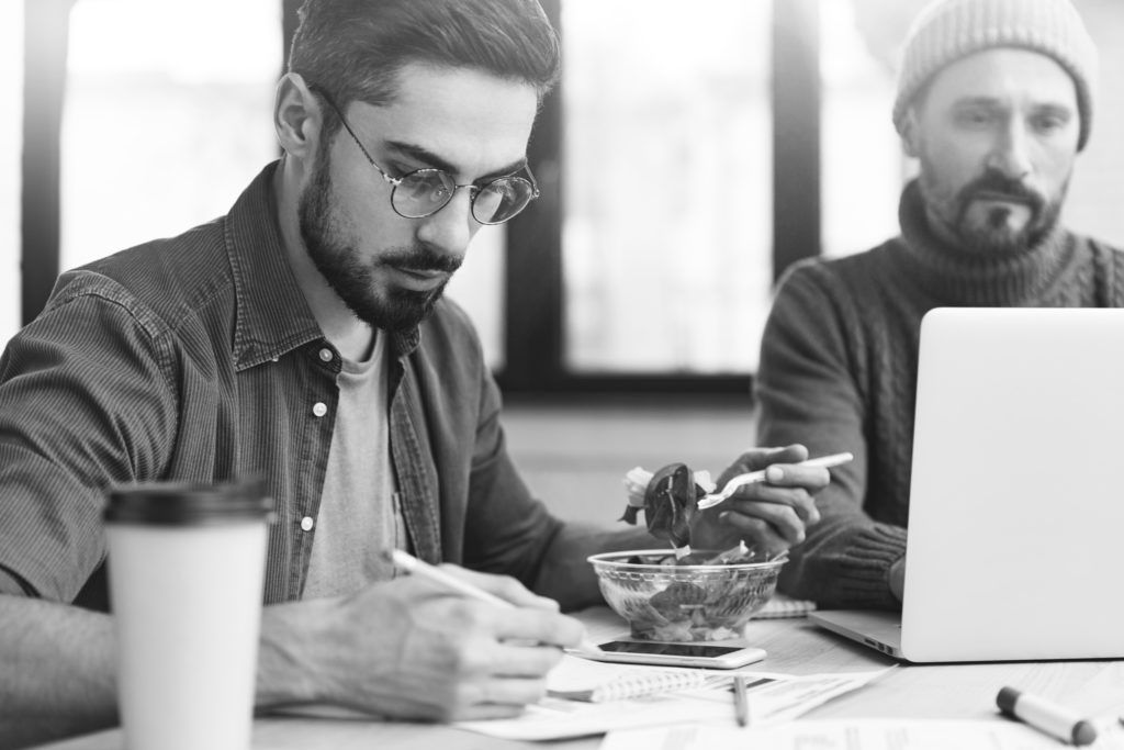 man eating while working