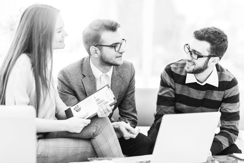 shutterstock_1135608683 professional consultants in group working in office