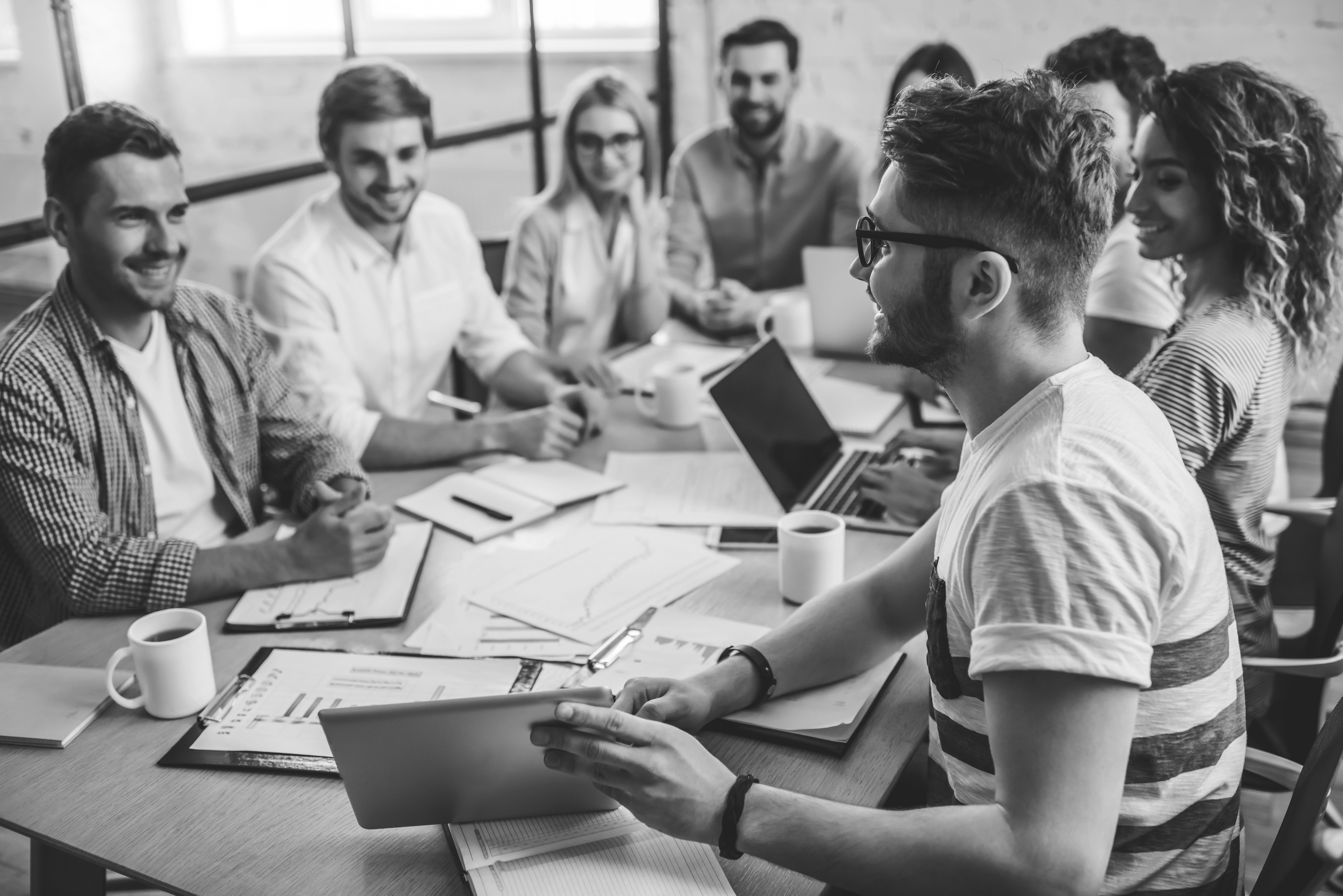 people talking at desk in office