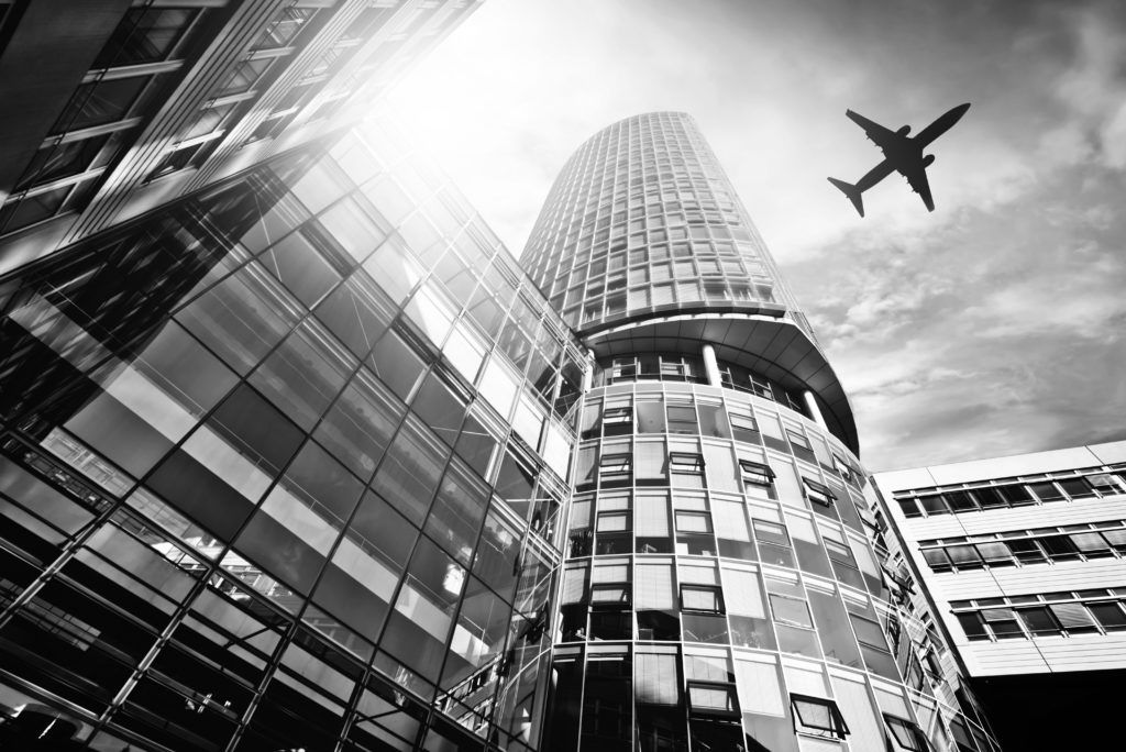 shutterstock_224776513 building with airplane flying overhead