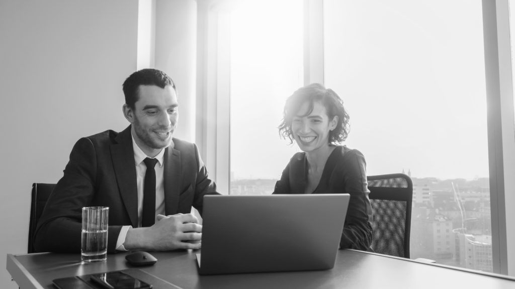 shutterstock_1233294091 consultants working together on laptop
