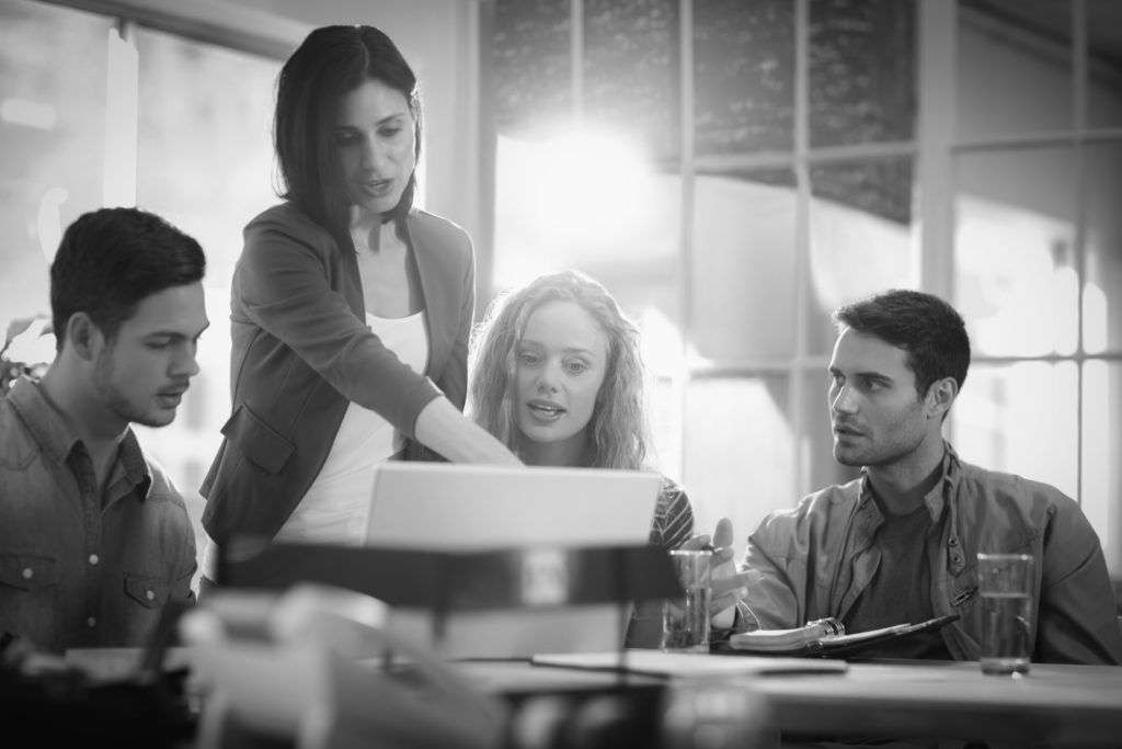 shutterstock_294489926 consultants in group working at desk