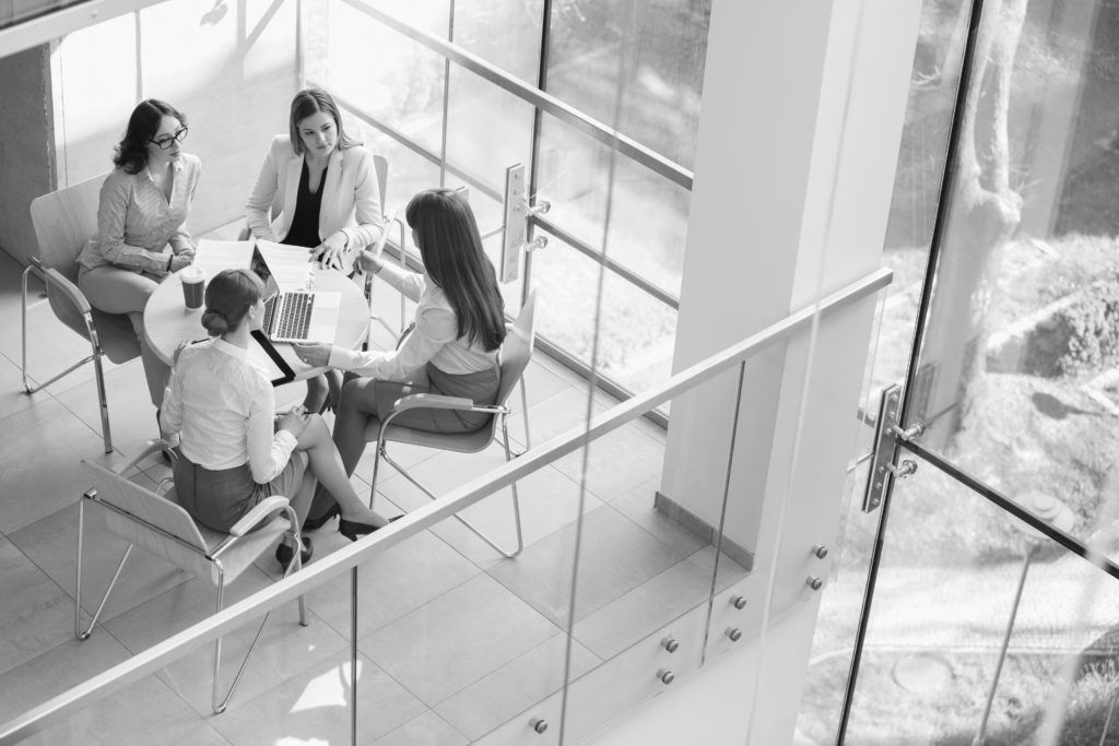 shutterstock_225478525 consultants in group working at desk
