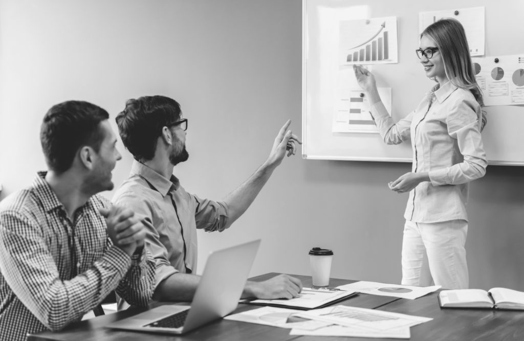 shutterstock_518941525 woman making presentation in office