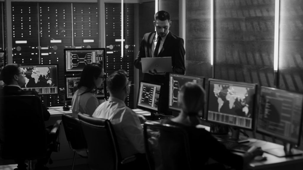 shutterstock_669170671-bw people working at high tech security station