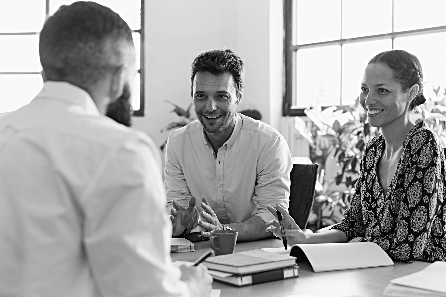 Business Team At The Meeting Mid adult business people having discussion at desk in office
