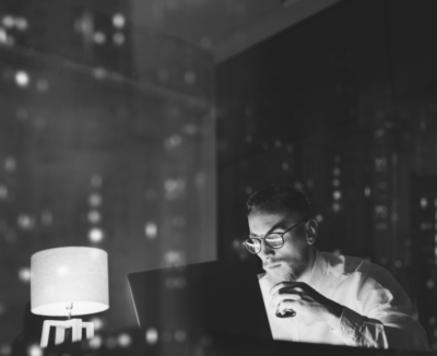 state-of-independence@2x man works on computer at night