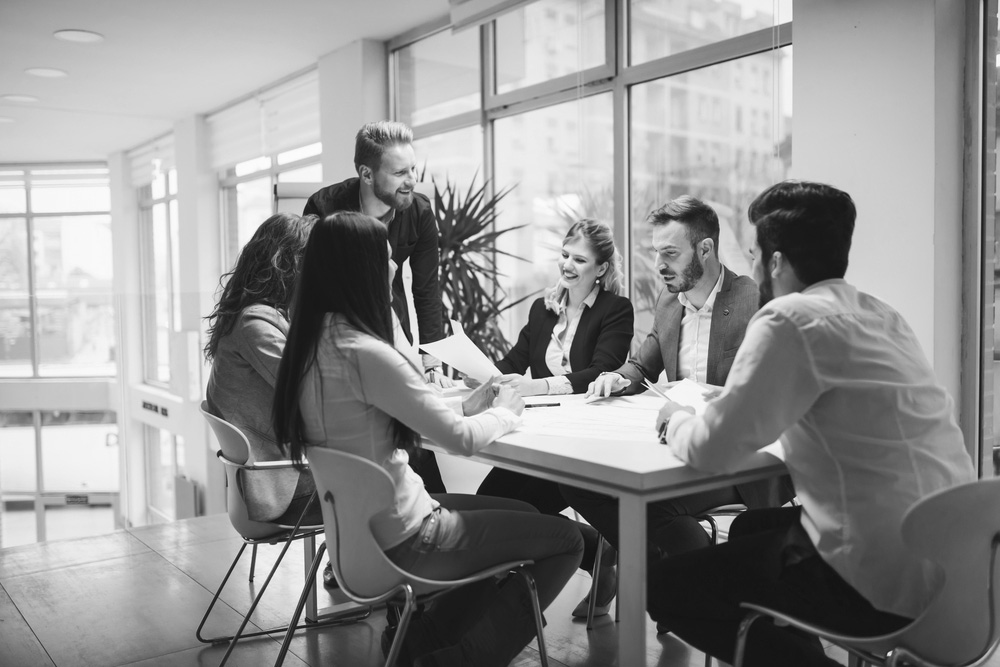 shutterstock_596352755-bw people talking at table