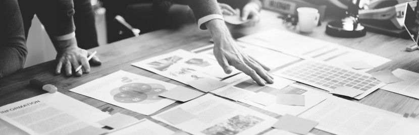 man working on documents on desk img