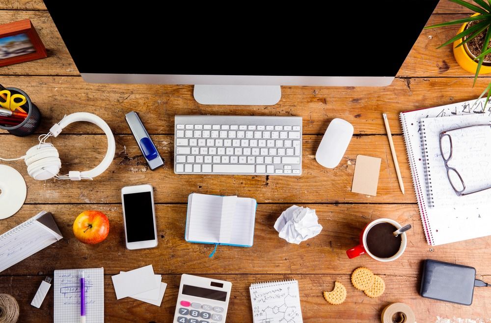 desk-with-various-gadgets-and-office-supplies-computer-smart-phone-and-other-devices-and-stationery-around-the-workplace