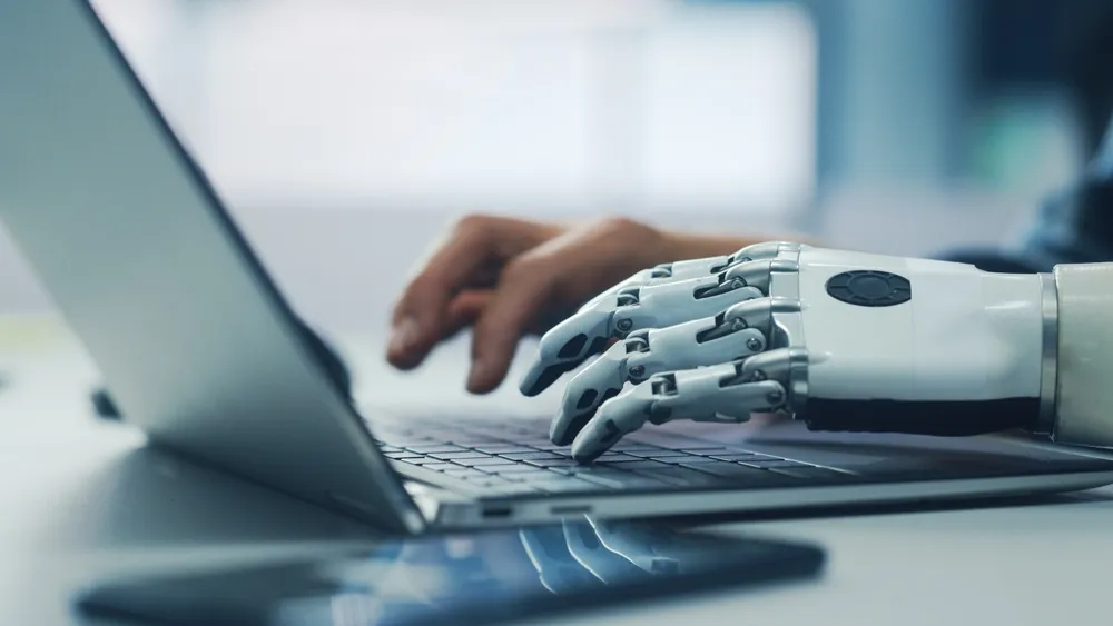 Close-up,On,Hands:,Person,With,Disability,Using,Prosthetic,Arm,To robot hand
